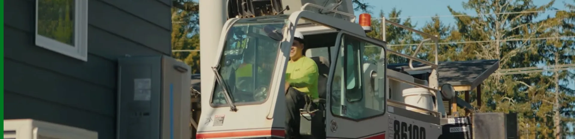 Westmore Construction operator in a heavy crane cab at a residential project site in Vancouver, WA