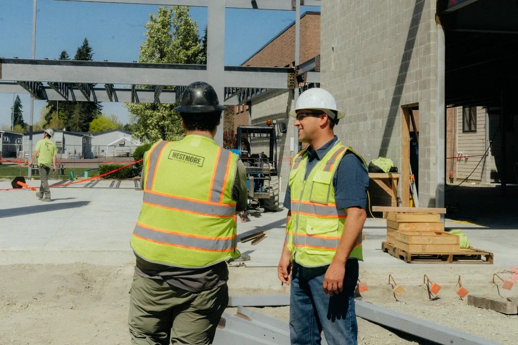 Westmore Construction project managers overseeing a commercial steel building site in Vancouver, WA, ensuring high-quality general contracting standards.