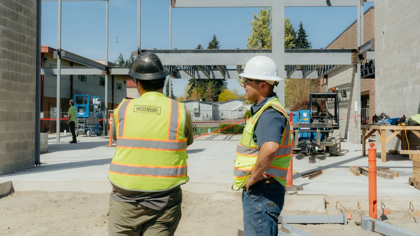 Westmore crew in branded safety vests at a steel frame job site