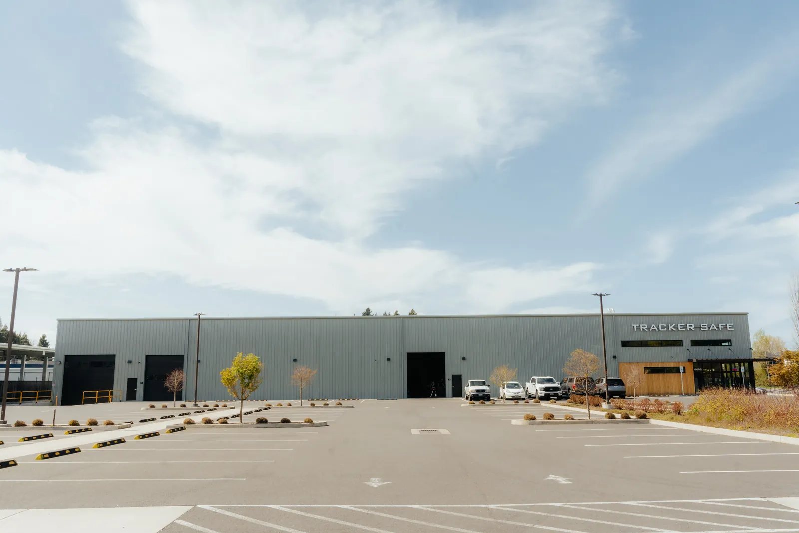 Front elevation of the finished Tracker Safe building with its parking lot and landscaping