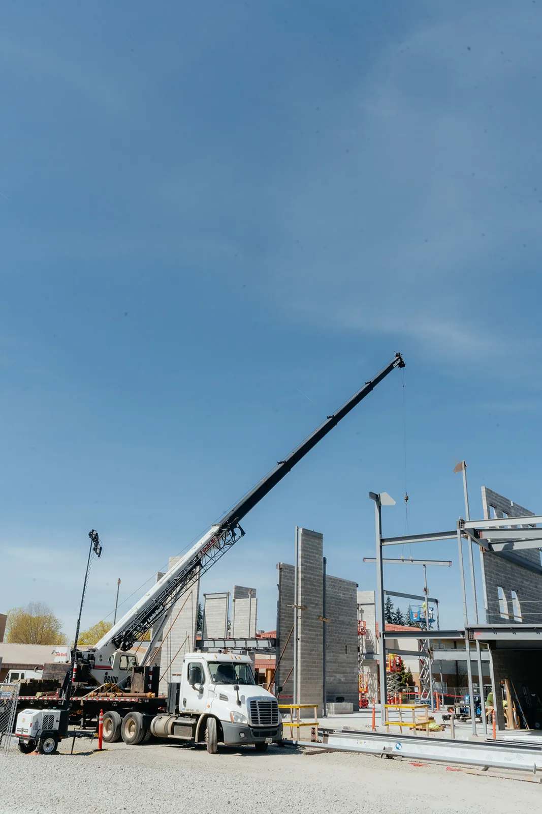 Westmore Link-Belt crane beside a partially erected steel and panel building