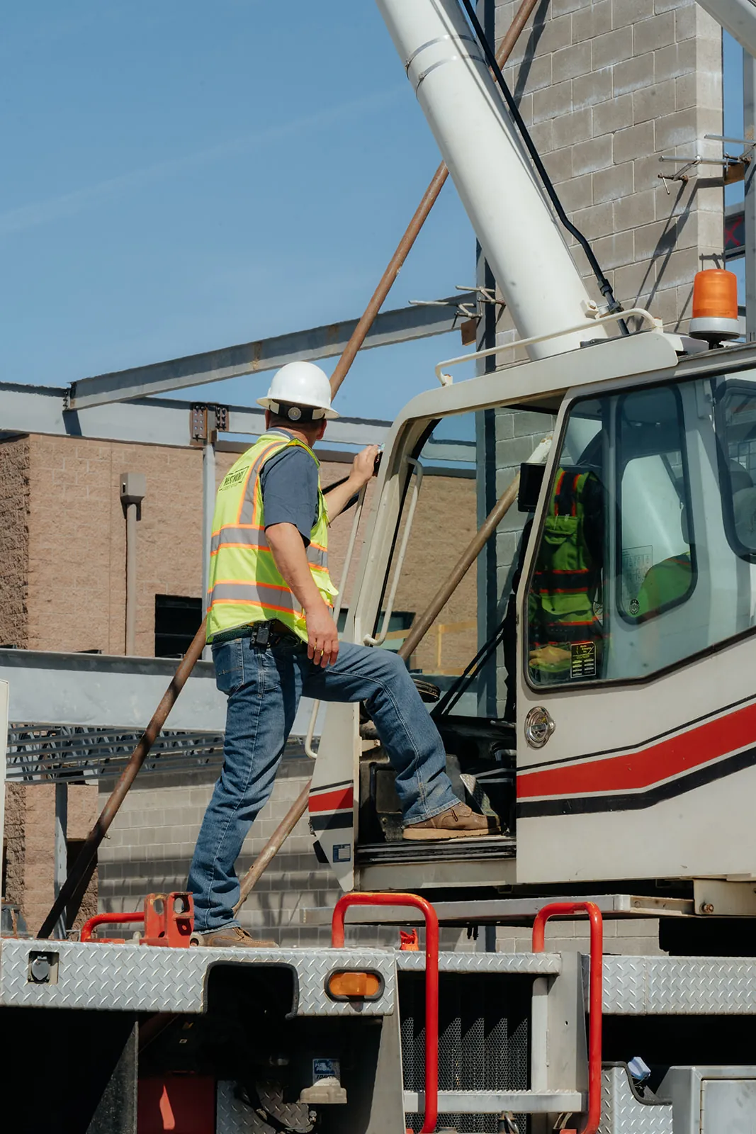 Westmore crew member in hi-vis climbing onto the crane deck