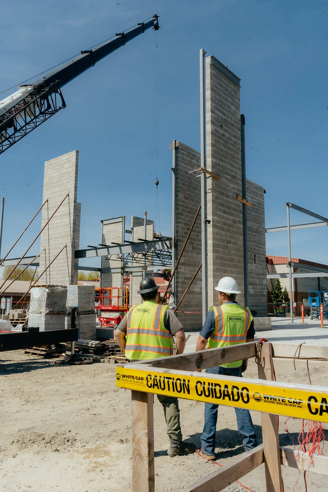 Westmore crane and crew behind caution tape during tilt-panel erection