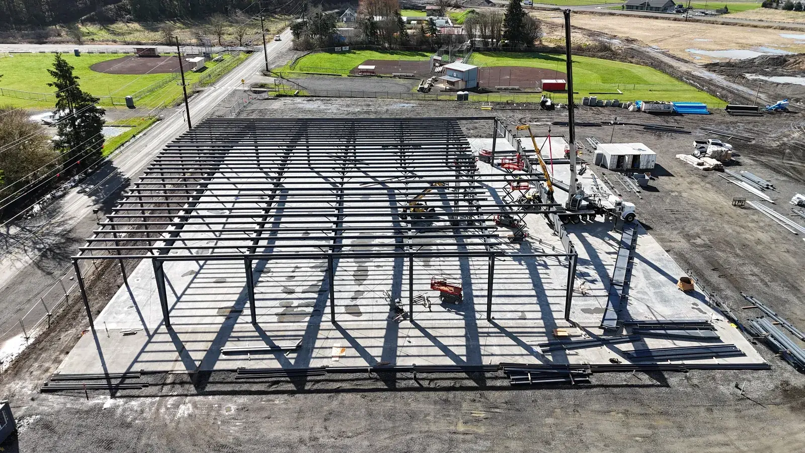 Aerial drone view of the fully erected Builders FirstSource steel frame in Woodland, WA